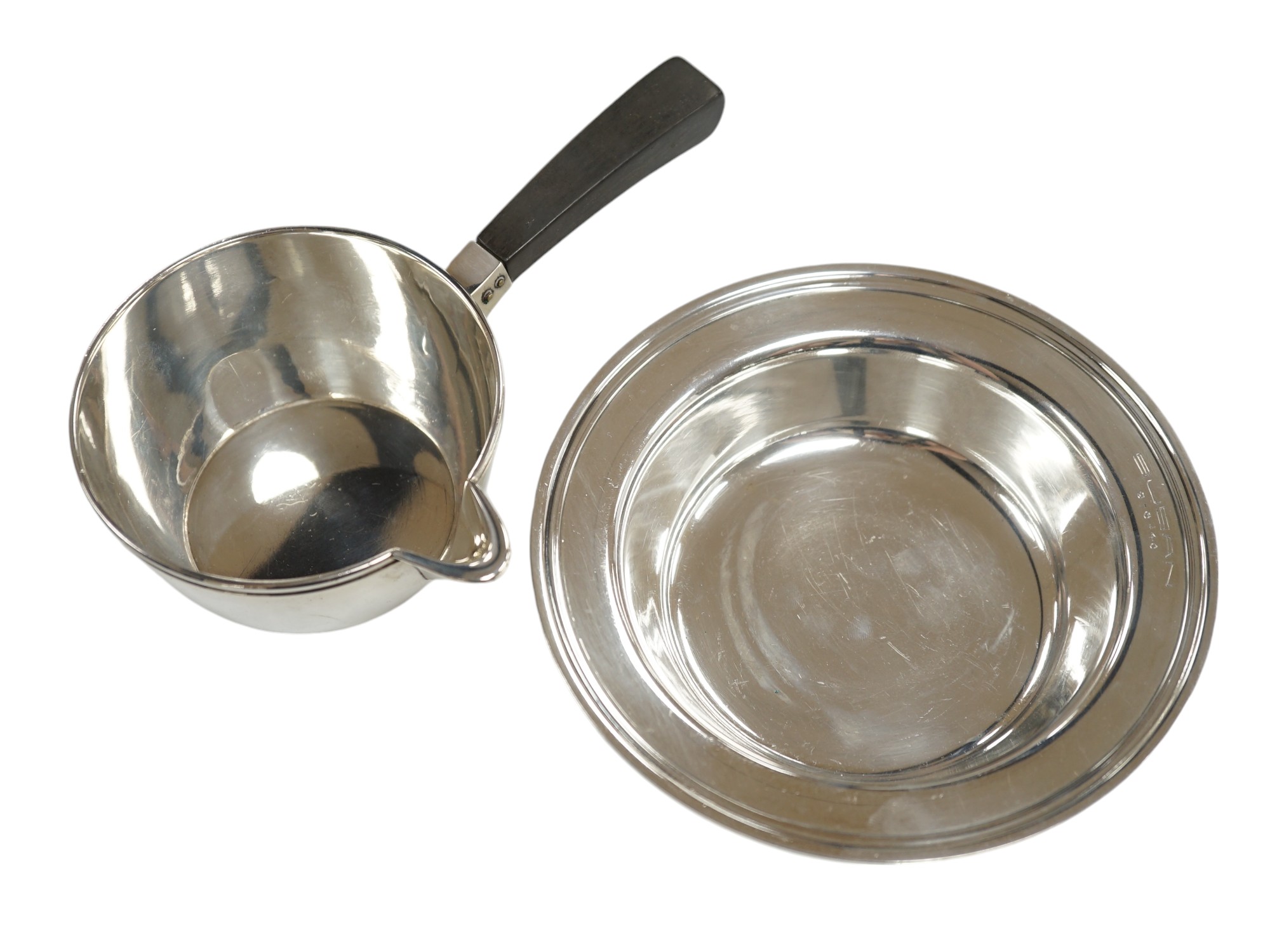 A 1940's Danish white metal bowl and small saucepan with wooden handle, the latter stamped Heimburger, gross 8.4oz. Condition - fair